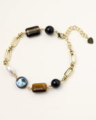 Gold-plated chain bracelet featuring tiger's eye, obsidian, freshwater pearls and abalone shell on white background
