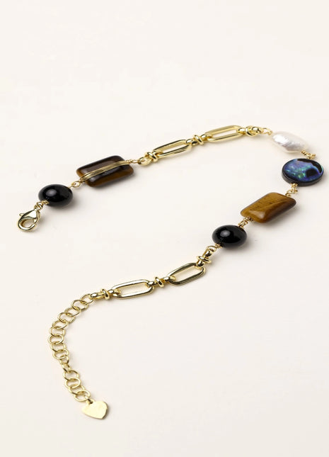 Gold-plated chain bracelet featuring tiger's eye, obsidian, freshwater pearls and abalone shell on white background