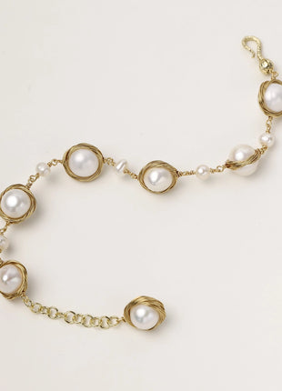 14K gold plated bracelet featuring wire-wrapped freshwater pearls in nest-like settings with adjustable chain closure