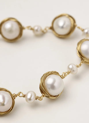 14K gold plated bracelet featuring wire-wrapped freshwater pearls in nest-like settings with adjustable chain closure