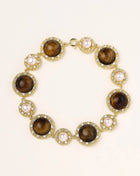 Ornate gold-plated bracelet with alternating brown tiger's eye stones and white freshwater pearls in crystal-accented settings