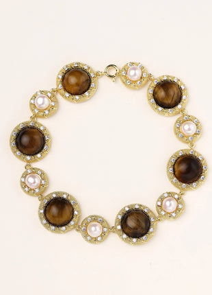 Ornate gold-plated bracelet with alternating brown tiger's eye stones and white freshwater pearls in crystal-accented settings