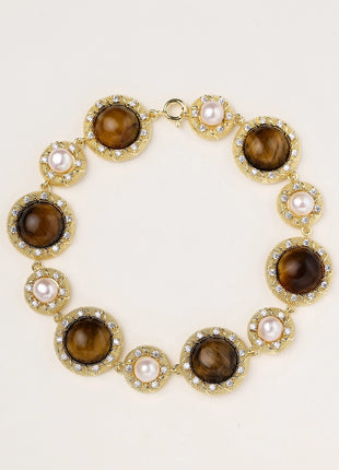 Ornate gold-plated bracelet with alternating brown tiger's eye stones and white freshwater pearls in crystal-accented settings