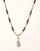 Gold-plated necklace with purple amethyst beads, pink pearls, and iridescent baroque pearl pendant beneath crystal star charm