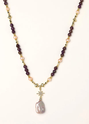 Gold-plated necklace with purple amethyst beads, pink pearls, and iridescent baroque pearl pendant beneath crystal star charm