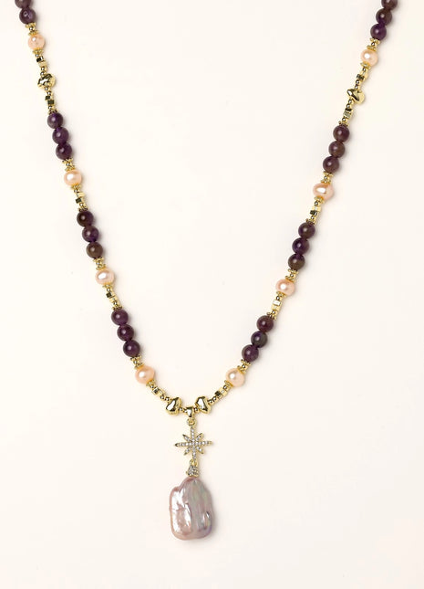 Gold-plated necklace with purple amethyst beads, pink pearls, and iridescent baroque pearl pendant beneath crystal star charm