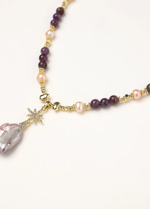 Gold-plated necklace with purple amethyst beads, pink pearls, and iridescent baroque pearl pendant beneath crystal star charm