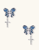 Ornate gold-plated butterfly earrings with blue enamel wings, white pearl centers, and silver cross dangles
