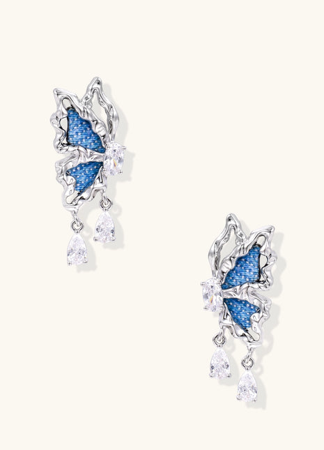 Gold-plated brass earrings featuring blue denim fabric insets and sparkling zirconia crystals with teardrop dangles