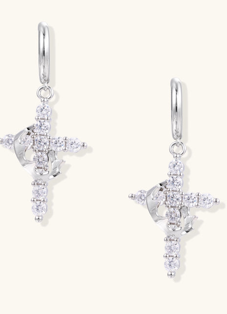 Ornate cross dangle earrings with zirconia stones and gold-plated brass construction on white background.