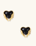 Pair of 18K gold plated earrings with wing design surrounding black resin heart centers on light background