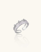 Adjustable gold-plated crown ring with zirconia crystals in ornate tiara design on white background.