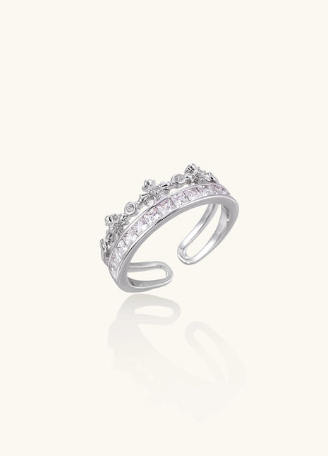 Adjustable gold-plated crown ring with zirconia crystals in ornate tiara design on white background.