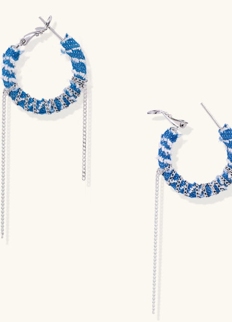 Blue and white checkered denim-wrapped hoop earrings with delicate silver chain dangles on neutral background