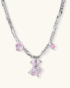 Adjustable gold-plated brass chain necklace with pink zirconia crystals and mixed link patterns on white background.