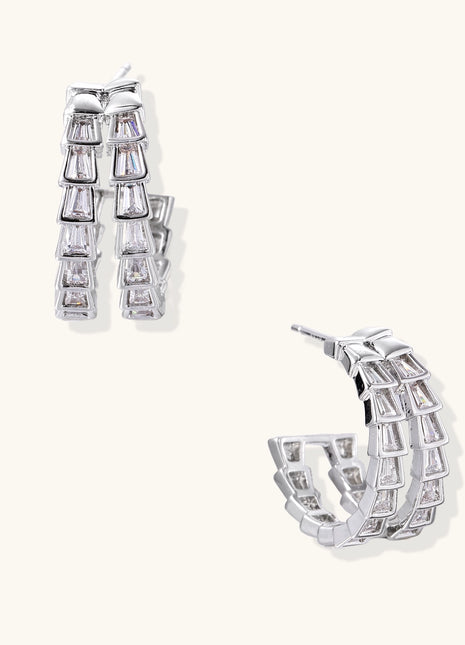 Gold-plated huggie hoops featuring vertical rows of clear baguette zirconia stones in geometric linear design