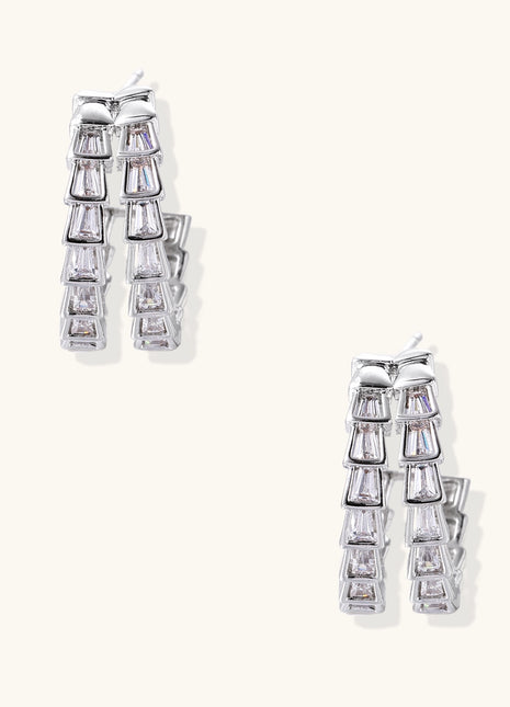 Gold-plated huggie hoops featuring vertical rows of clear baguette zirconia stones in geometric linear design
