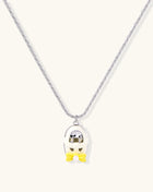 Minimalist gold plated brass necklace with cute capsule pendant featuring yellow bow detail on neutral background.