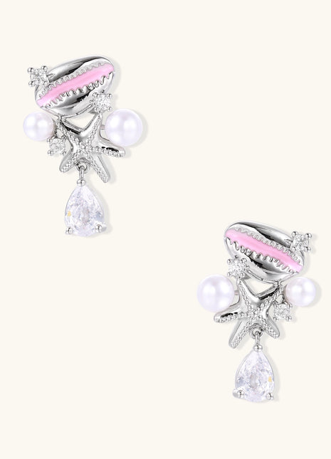 Gold-plated dangle earrings with enamel shell charms, white pearls, starfish accents, and crystal drops on white background.