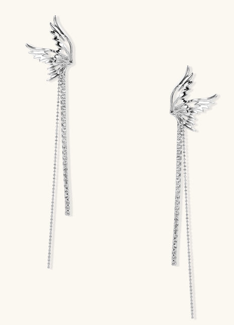 Gold-plated angel wing earrings with long cascading crystal chains on neutral background, showing intricate feather details