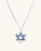 Gold-plated lotus pendant necklace with blue zirconia stones and white beads on adjustable layered chains