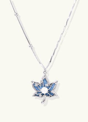 Gold-plated lotus pendant necklace with blue zirconia stones and white beads on adjustable layered chains