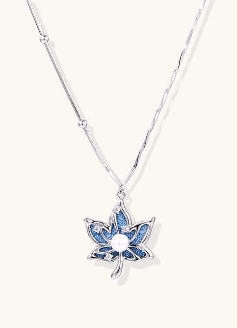 Gold-plated lotus pendant necklace with blue zirconia stones and white beads on adjustable layered chains