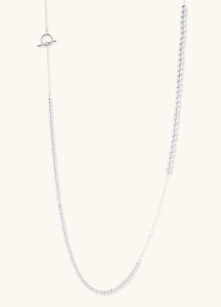 Sterling silver necklace with graduated pearl beads and delicate chain sections featuring a toggle clasp closure.