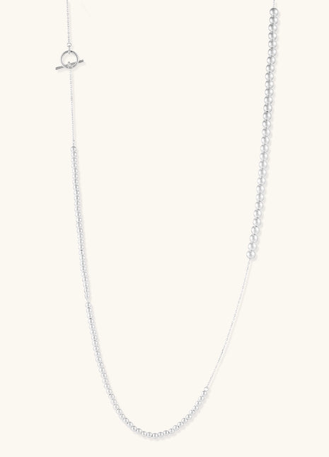 Sterling silver necklace with graduated pearl beads and delicate chain sections featuring a toggle clasp closure.