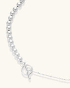 Sterling silver necklace with graduated pearl beads and delicate chain sections featuring a toggle clasp closure.