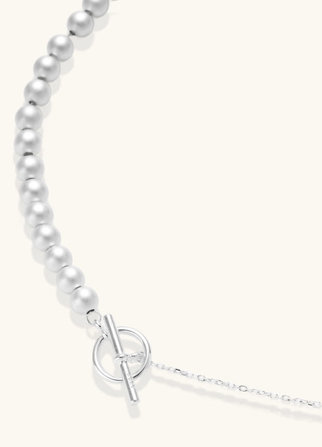 Sterling silver necklace with graduated pearl beads and delicate chain sections featuring a toggle clasp closure.