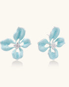 Turquoise blue enamel flower earrings with crystal centers and gold-plated brass posts on white background.