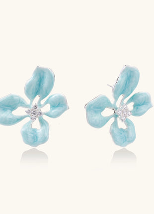 Turquoise blue enamel flower earrings with crystal centers and gold-plated brass posts on white background.