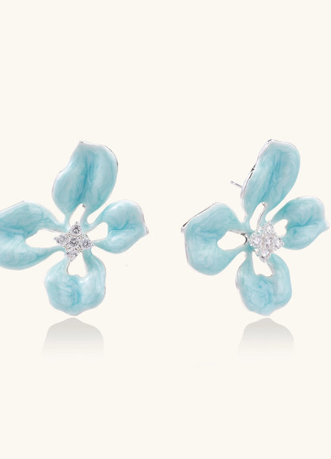 Turquoise blue enamel flower earrings with crystal centers and gold-plated brass posts on white background.