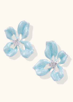 Turquoise blue enamel flower earrings with crystal centers and gold-plated brass posts on white background.