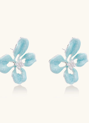 Turquoise blue enamel flower earrings with crystal centers and gold-plated brass posts on white background.