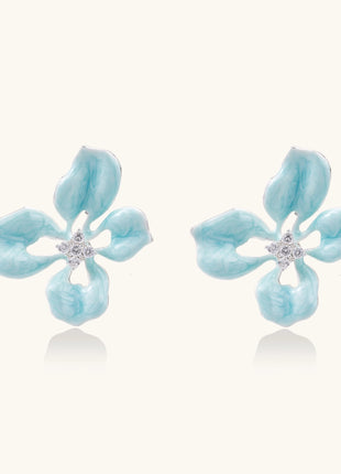 Turquoise blue enamel flower earrings with crystal centers and gold-plated brass posts on white background.