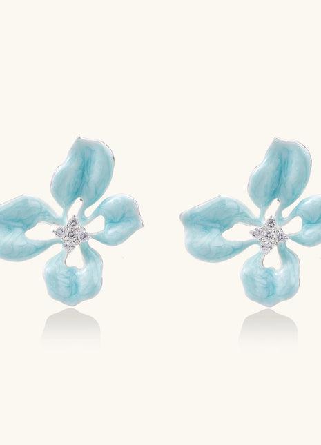 Turquoise blue enamel flower earrings with crystal centers and gold-plated brass posts on white background.