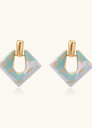 Diamond-shaped gold-plated earrings with pastel marble enamel in turquoise and lavender swirls on beige background