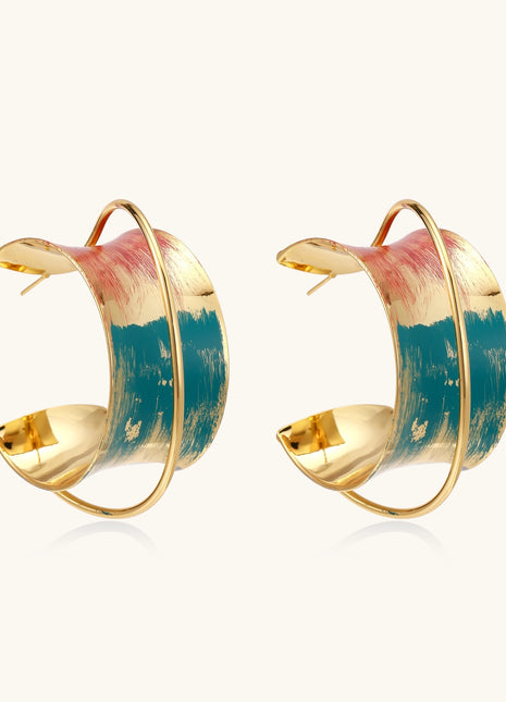 Gold-plated hoop earrings with colorful enamel brushstroke patterns in turquoise, coral, and gold tones