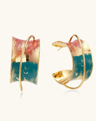 Gold-plated hoop earrings with colorful enamel brushstroke patterns in turquoise, coral, and gold tones