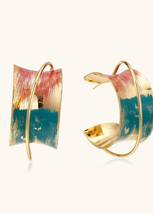 Gold-plated hoop earrings with colorful enamel brushstroke patterns in turquoise, coral, and gold tones
