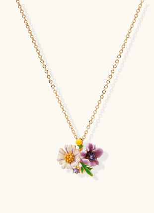 Delicate 18K gold plated necklace featuring colorful enamel flowers in pink and white with green leaves on chain