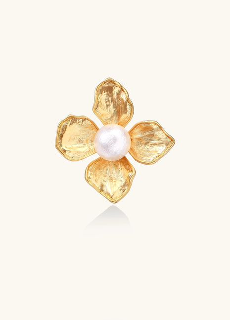 Gold-plated brass ring with dimensional 5-petal flower design and white cotton pearl center on neutral background.