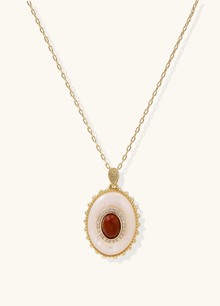 Oval gold-plated pendant featuring mother-of-pearl base with carnelian center stone and crystal accents on delicate chain