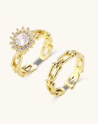 Two gold-plated rings with cubic zirconia halo design and chain-link band on white background, adjustable sizing.