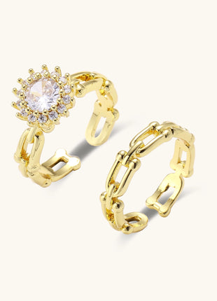 Two gold-plated rings with cubic zirconia halo design and chain-link band on white background, adjustable sizing.