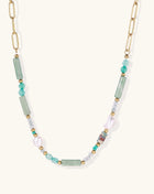 Gold-plated chain necklace with green prasem quartz, freshwater pearls, and mixed beads in modern asymmetrical design