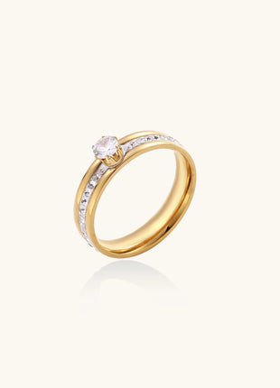 14K gold plated ring with center rhinestone and accent stones along the band on white background.