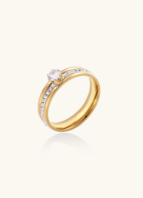 14K gold plated ring with center rhinestone and accent stones along the band on white background.